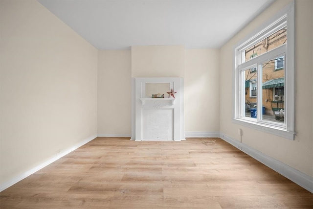 unfurnished room with light wood-type flooring