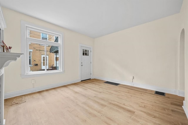 foyer featuring a fireplace and light hardwood / wood-style floors