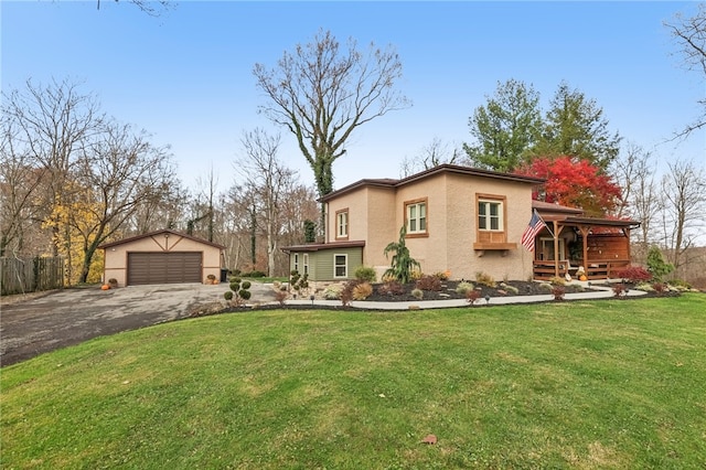 view of front of property with a front yard, an outdoor structure, and a garage