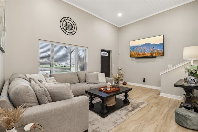 living room with light wood-type flooring and ornamental molding