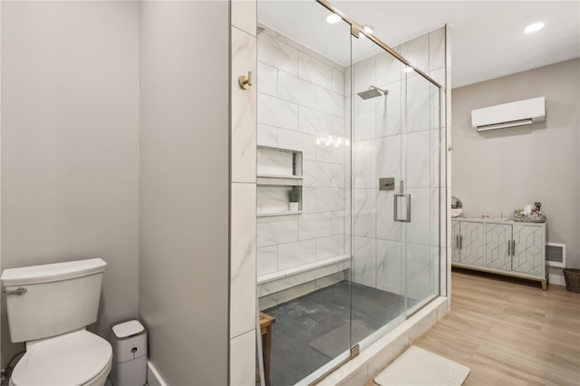 bathroom featuring an AC wall unit, hardwood / wood-style floors, an enclosed shower, and toilet