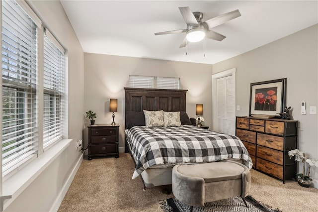 carpeted bedroom featuring ceiling fan and a closet