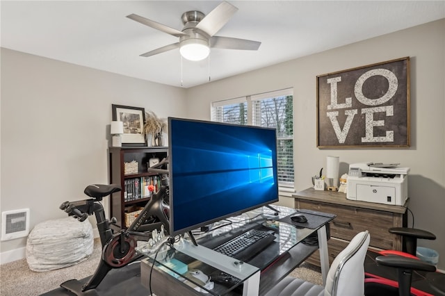 carpeted office featuring ceiling fan