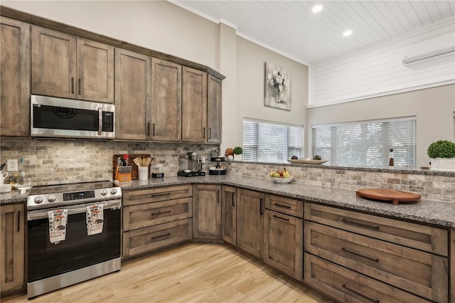 kitchen with backsplash, dark stone countertops, light wood-type flooring, appliances with stainless steel finishes, and wood ceiling