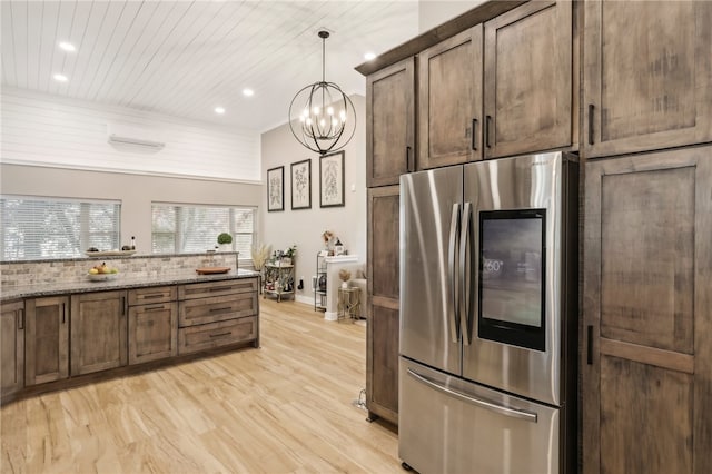 kitchen featuring dark stone counters, decorative light fixtures, light hardwood / wood-style floors, wood ceiling, and stainless steel refrigerator