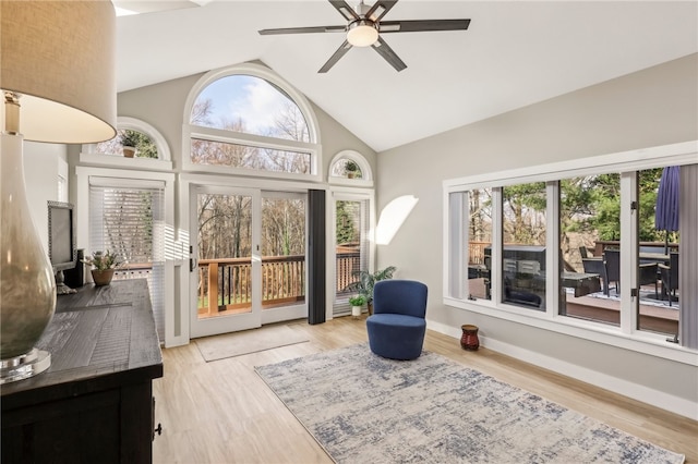 sunroom featuring ceiling fan, a healthy amount of sunlight, and vaulted ceiling