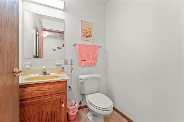 bathroom with tile patterned floors, vanity, and toilet