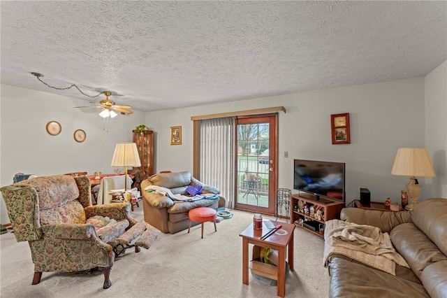 carpeted living room featuring ceiling fan and a textured ceiling