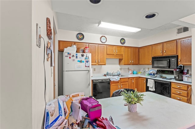 kitchen featuring black appliances and sink