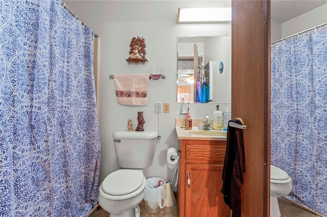 bathroom featuring tile patterned floors, vanity, toilet, and a skylight