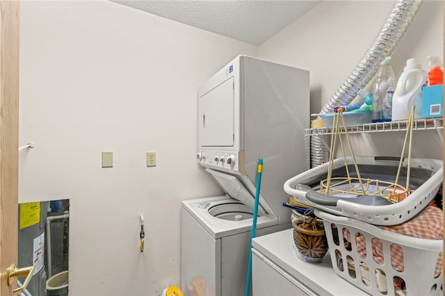 washroom with stacked washing maching and dryer and a textured ceiling