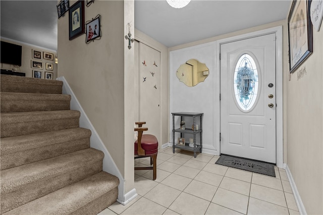 foyer entrance with light tile patterned floors