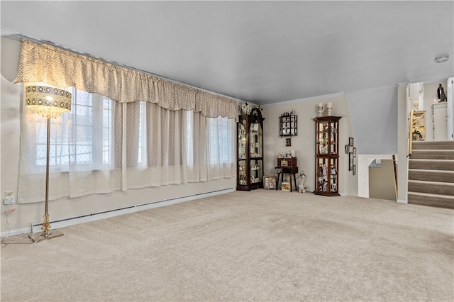 empty room with carpet flooring, ornamental molding, and a baseboard heating unit