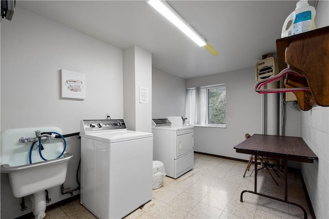 clothes washing area with washer and clothes dryer and sink