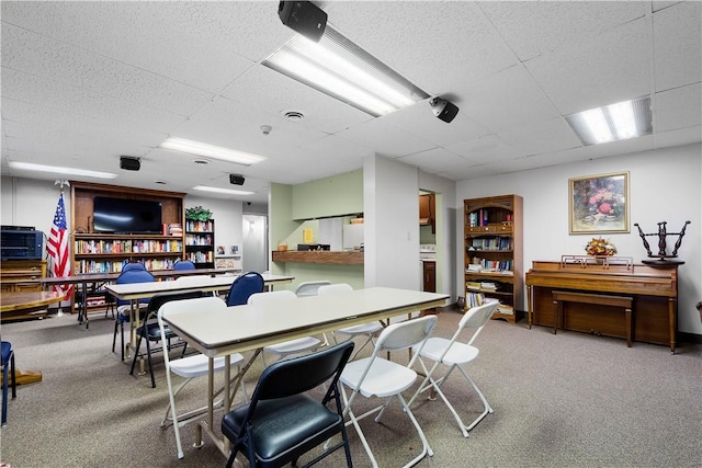 dining room with carpet flooring and a paneled ceiling