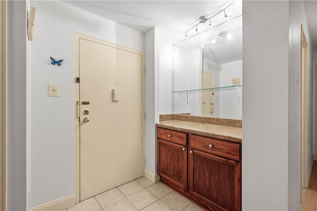 bathroom featuring tile patterned flooring and vanity