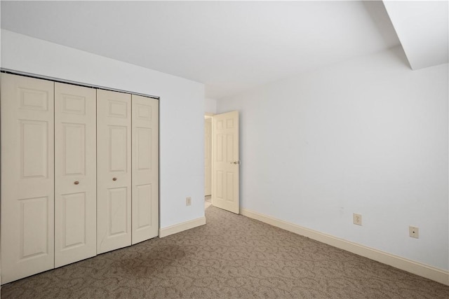 unfurnished bedroom featuring a closet and carpet floors