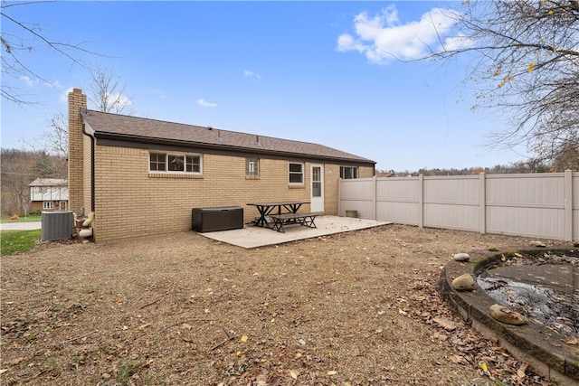 rear view of house with cooling unit and a patio area