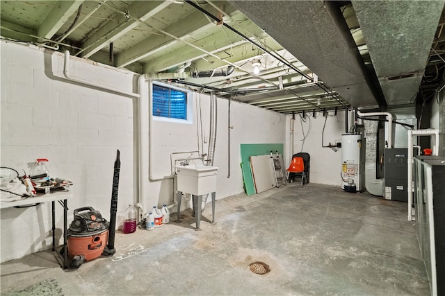 basement featuring water heater and sink