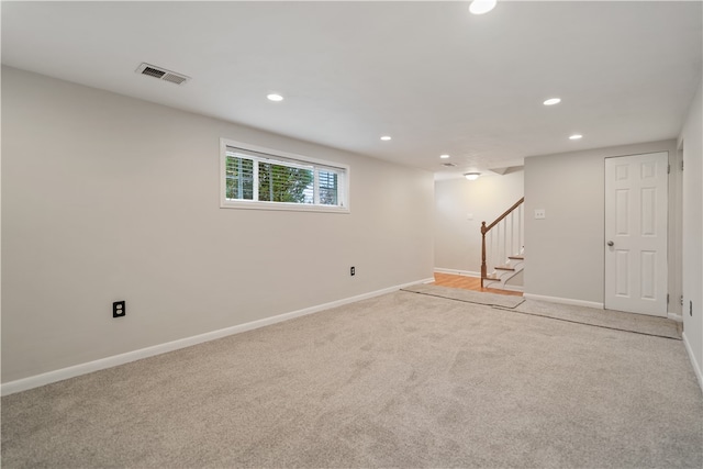 basement featuring light colored carpet