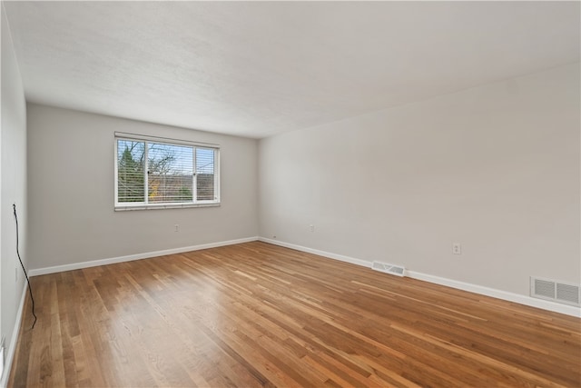 unfurnished room featuring hardwood / wood-style flooring