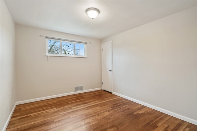 empty room featuring wood-type flooring