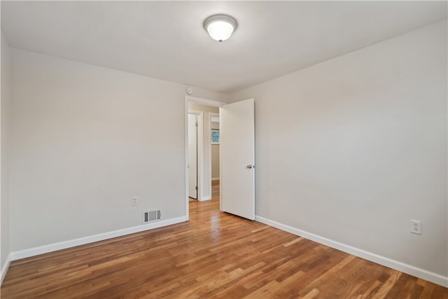 spare room featuring hardwood / wood-style flooring