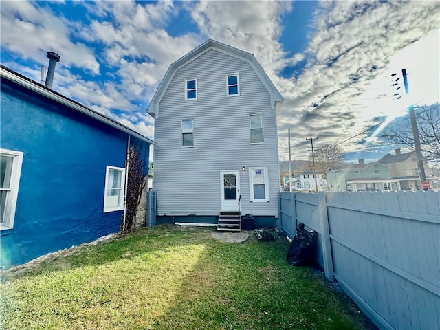 back of house with a lawn