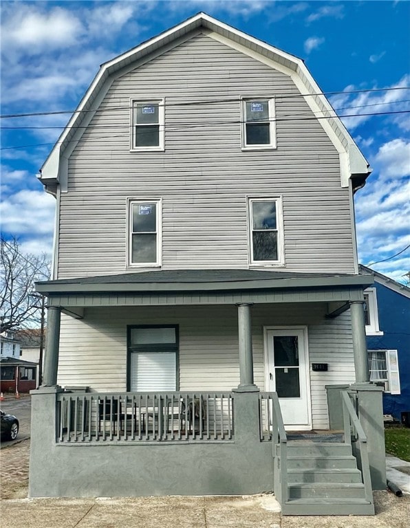 rear view of property with covered porch