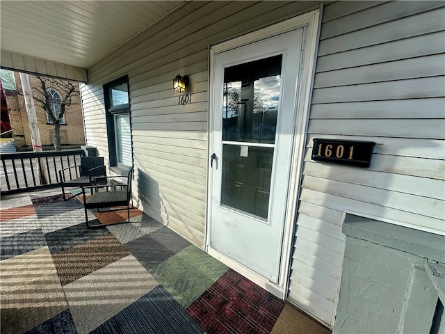 view of exterior entry featuring a porch