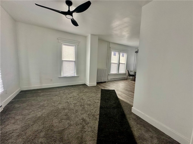 spare room with radiator and ceiling fan