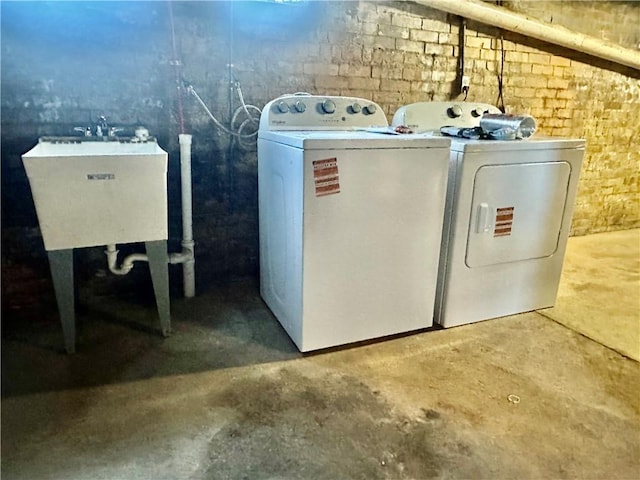 washroom featuring washer and dryer and sink