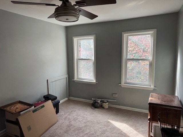 misc room featuring light colored carpet and ceiling fan