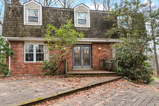 rear view of property with french doors and a deck