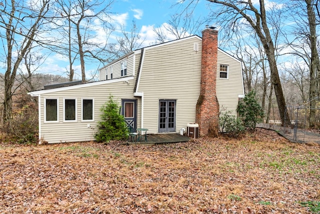 rear view of house with central AC unit