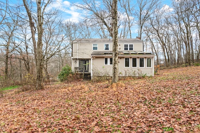 rear view of property with a wooden deck