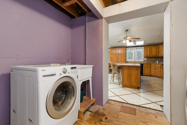 laundry room featuring ceiling fan, sink, light tile patterned floors, and washer / dryer