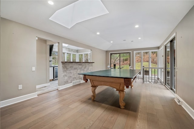 game room with light wood-type flooring, a skylight, beverage cooler, and billiards