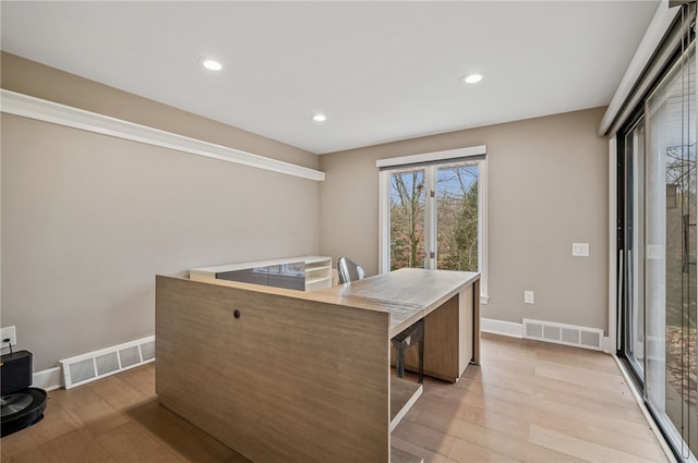 kitchen with a center island, french doors, and light wood-type flooring