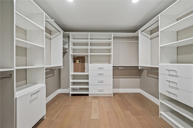 walk in closet with light wood-type flooring