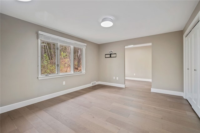 empty room with light hardwood / wood-style floors