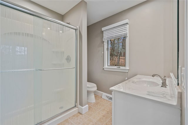 bathroom with tile patterned floors, toilet, vanity, and walk in shower