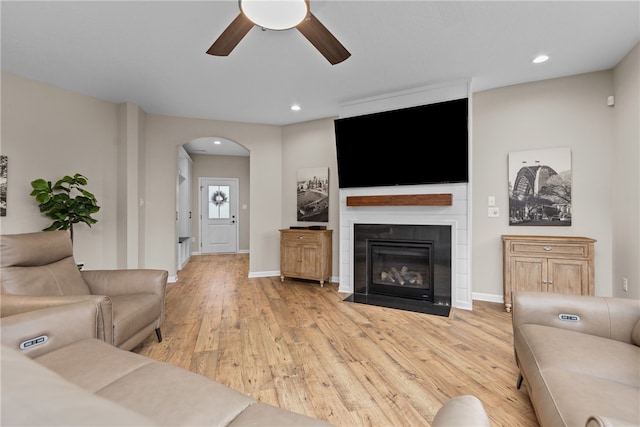 living room with ceiling fan and light hardwood / wood-style floors