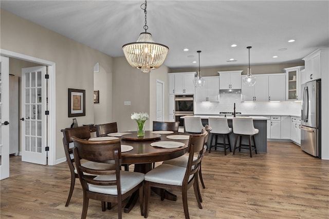 dining space featuring a notable chandelier and dark hardwood / wood-style floors