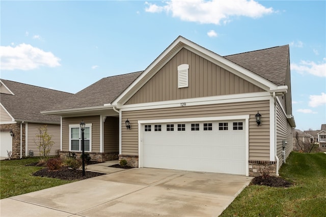 craftsman-style house with a front yard and a garage