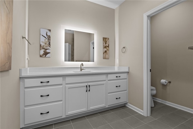 bathroom featuring tile patterned floors, vanity, and toilet