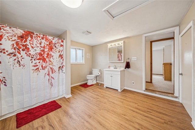 bathroom with vanity, hardwood / wood-style flooring, and toilet