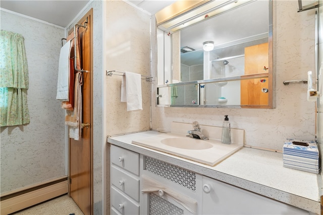 bathroom featuring baseboard heating and vanity