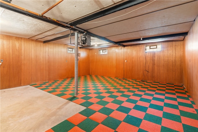 basement featuring wooden walls