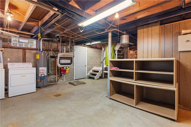 basement featuring independent washer and dryer, gas water heater, heating unit, and wooden walls